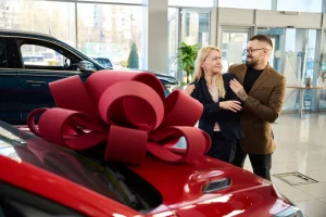 The happy couple are taking delivery of their new car in showroom after using Jade Car Loans for finance